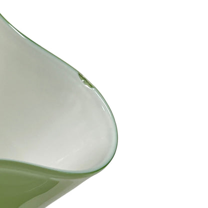close up of a glass lampshade on a white background