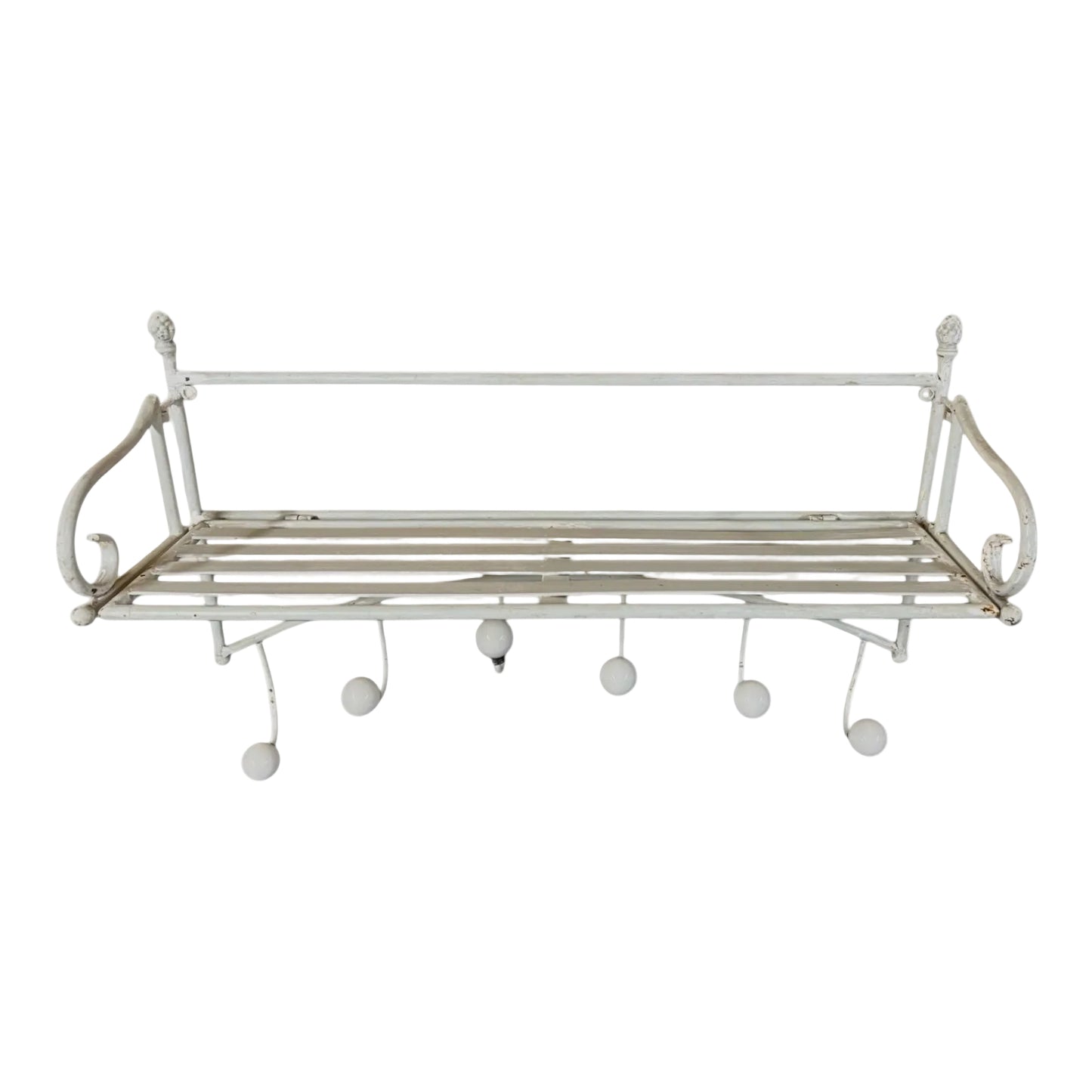 White metal wall shelf with hooks on a white background