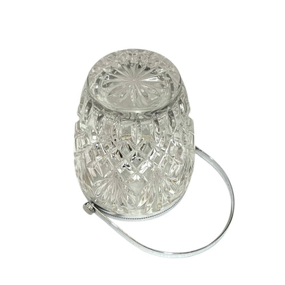 Close up of a French vintage glass ice bucket with silver rim on a white background