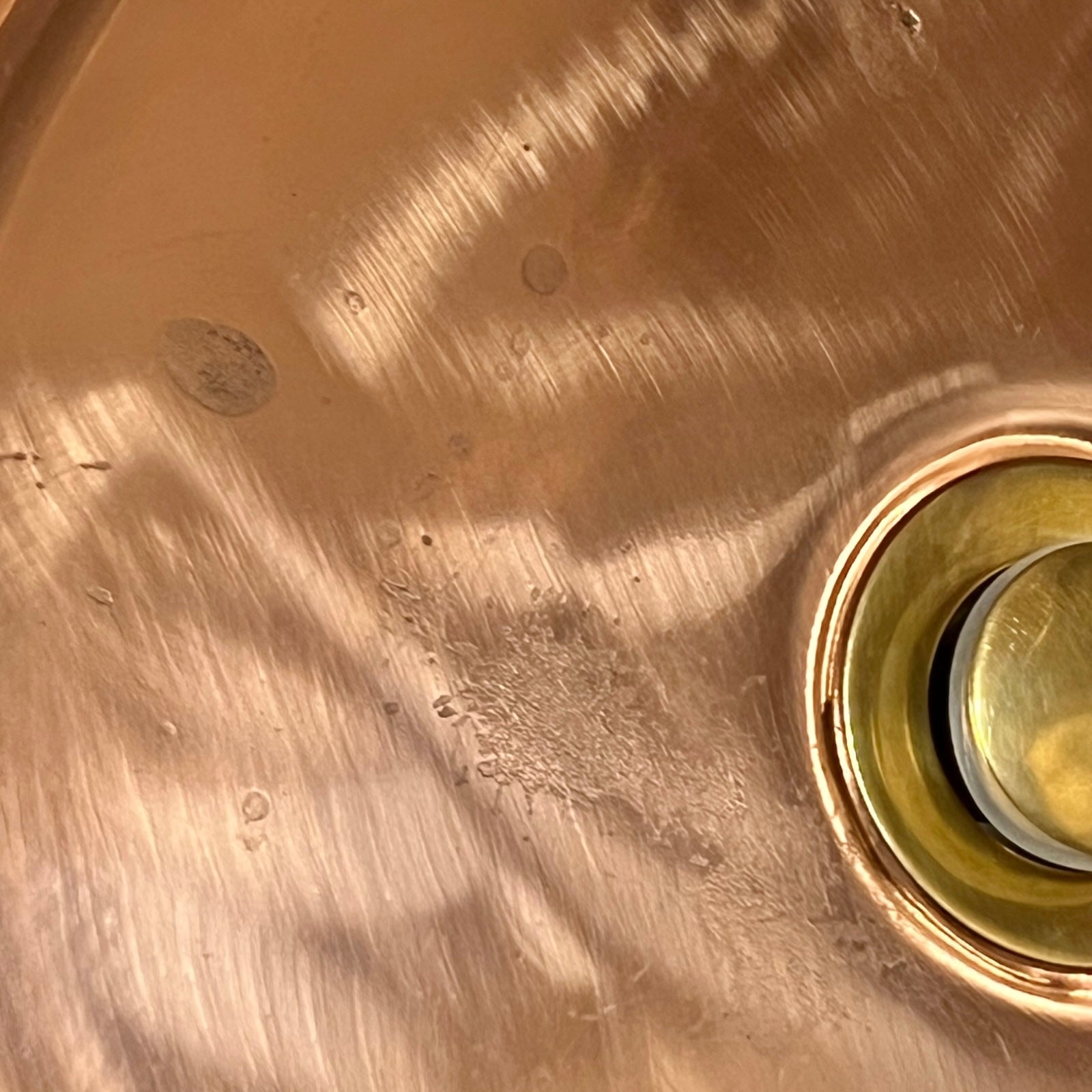 Close up of a copper basin sink on a white background