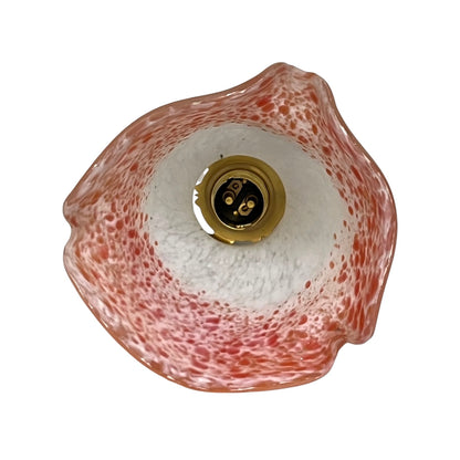 Inside view of a glass lampshade and brass bulb holder displayed on a white background 