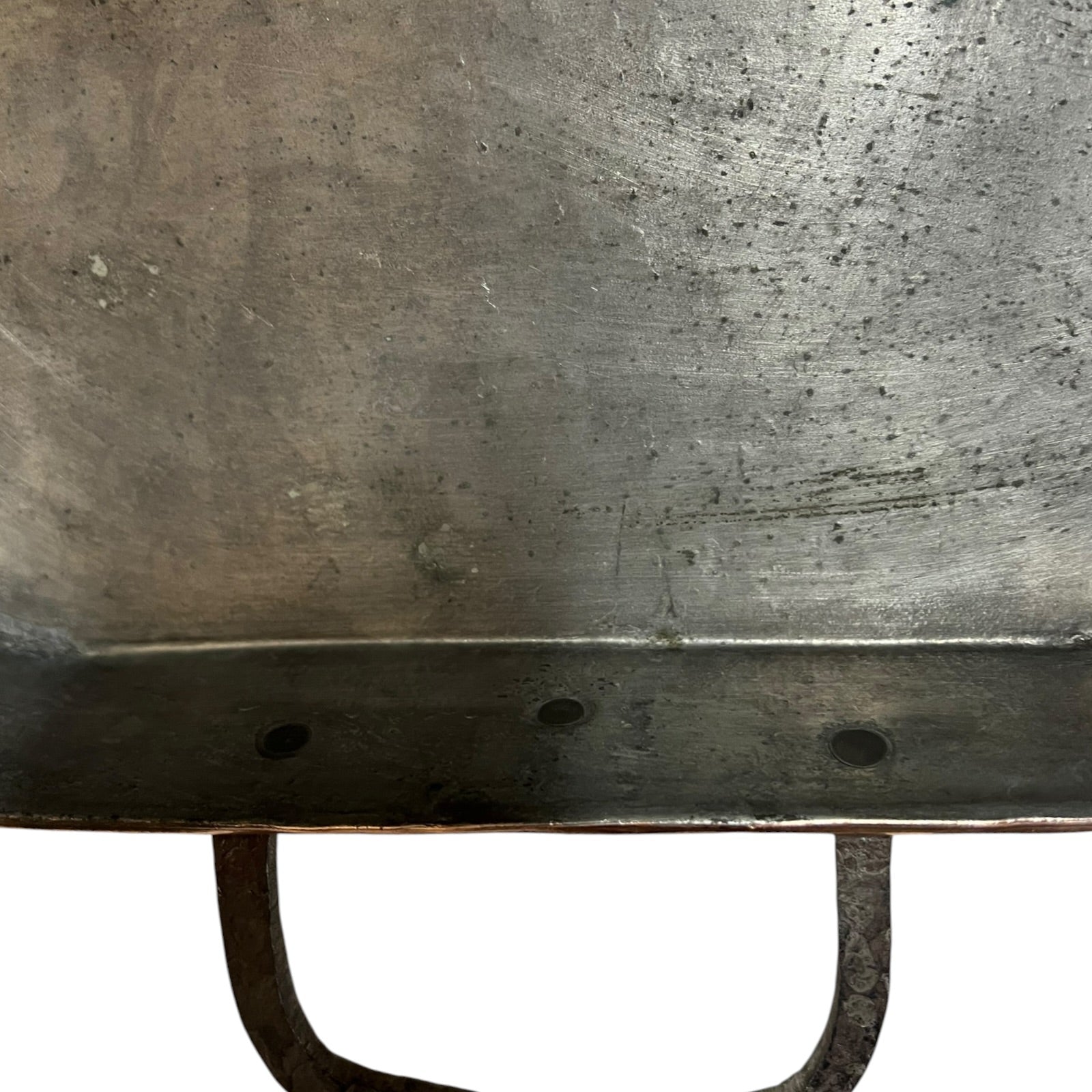 Close up of a copper roasting pan with a long handle on a white background