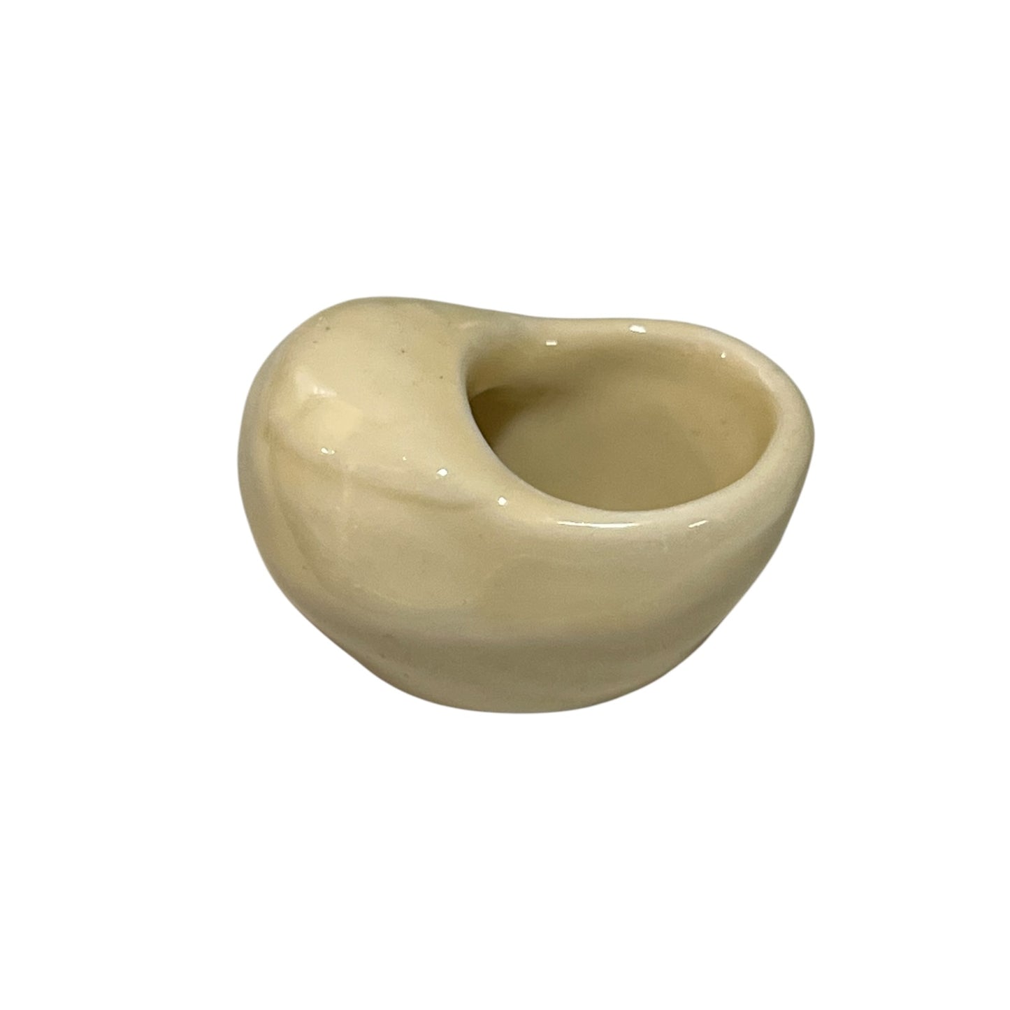 Beige ceramic snail shaped cup on a white background