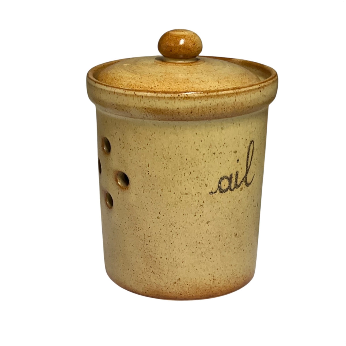 Side view of a speckled beige ceramic ail canister with a matching lid and knob, featuring the word 'ail' written in black cursive on the front, isolated on a white background.