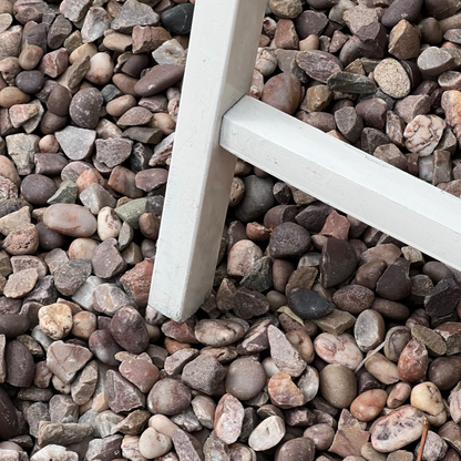 Close-up detail of French wooden slatted chairs, highlighting their condition in an outdoor setting.