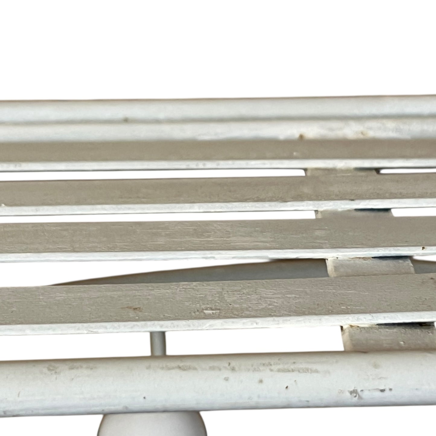 Close-up of a metal she with visible wear and tear on a white background