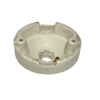 A white ceramic ceiling rose inside view on a white surface.