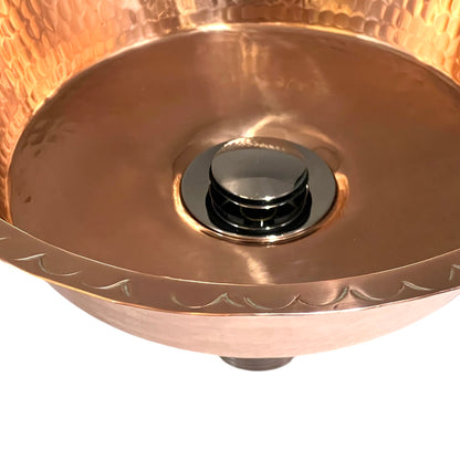 Copper sink with a chrome waste on a white background