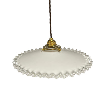 A vintage-style pendant light with a white frosted glass shade featuring a scalloped, fluted edge and a gold metal top cap, suspended by a dark brown cord against a white background.