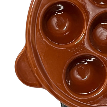Brown ceramic egg ,snail, or escargots plates with multiple compartments on a white background