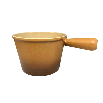 Brown Le Creuset vintage saucepan with handle on a white background