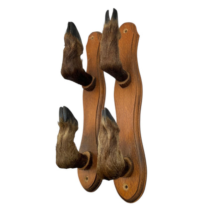 Wooden wall hook with animal fur accents on a white background