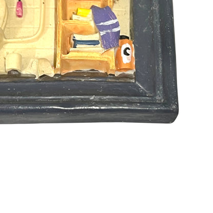 Close-up of a framed picture with a blue border on a white background