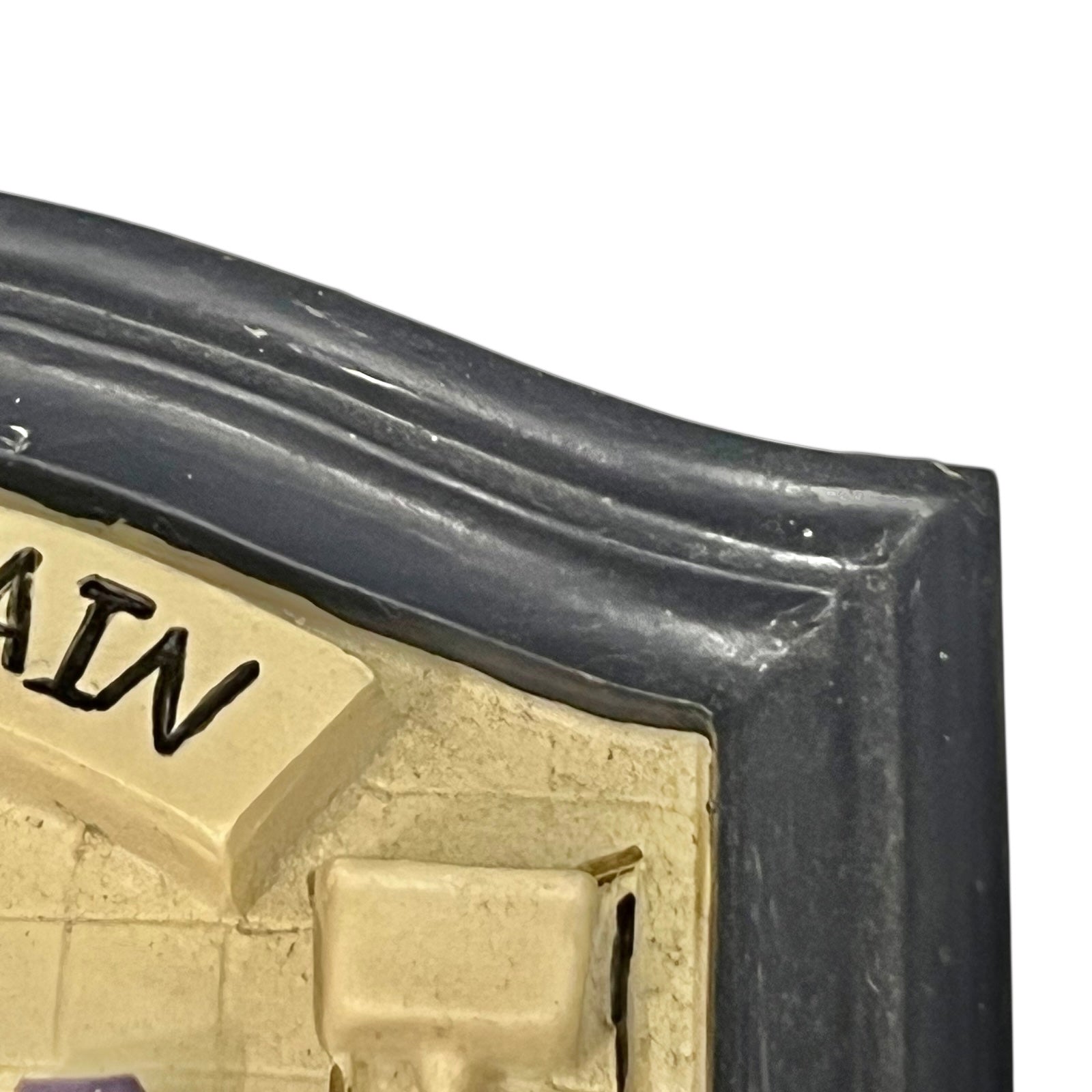 Close-up of a vintage bathroom door sign on a white background