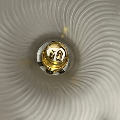 Close up of a vintage glass lampshade and brass fittings