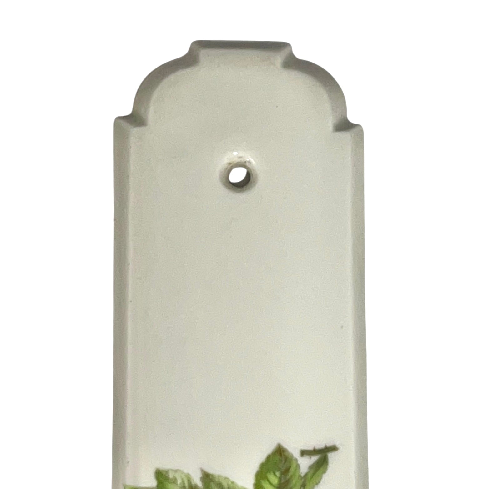 close up of door push plate with a yellow rose decoration on a white background