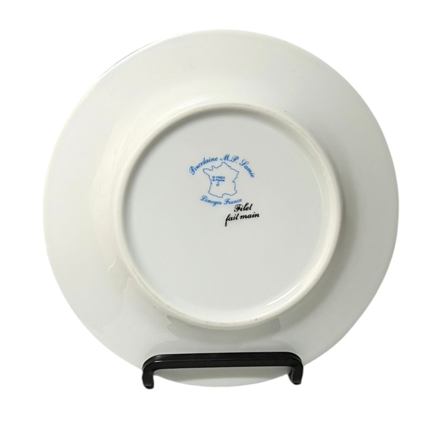 White plate with blue text on a stand against a white background