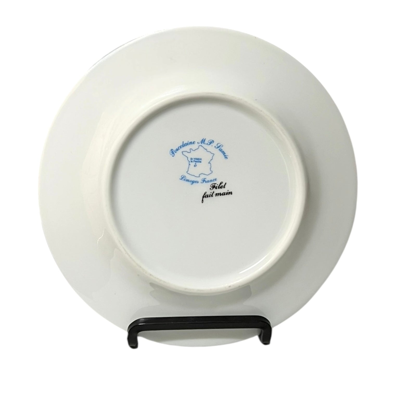 White plate with blue text on a stand against a white background