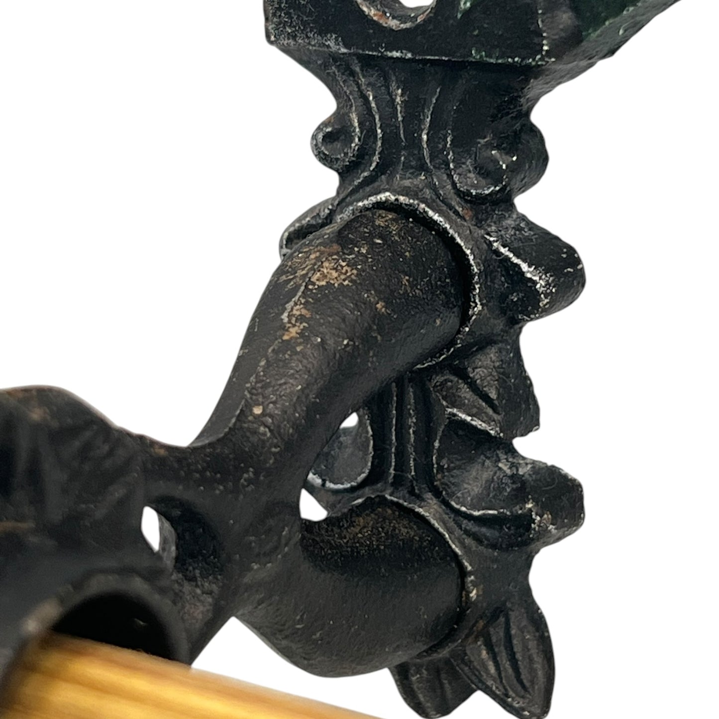 close up of a cast iron kitchen roll holder on a white background 