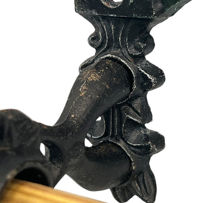 close up of a cast iron kitchen roll holder on a white background 