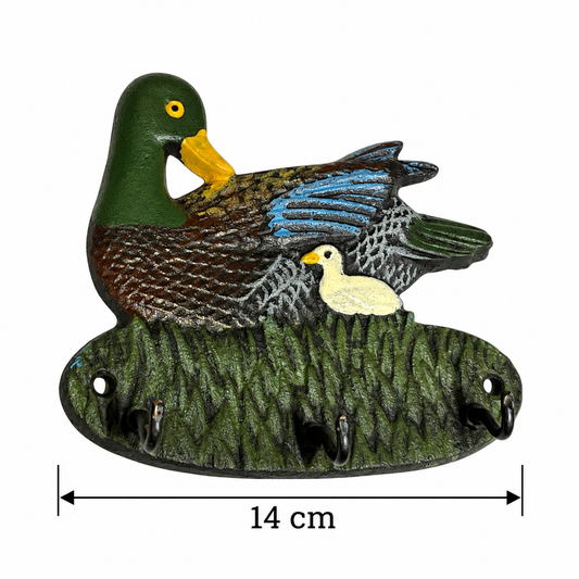A cast iron duck and duckling wall hook holder with a mother duck, a small duckling, and three hanging hooks on a textured reeds base. A dimension overlay indicates a width of 14 cm.