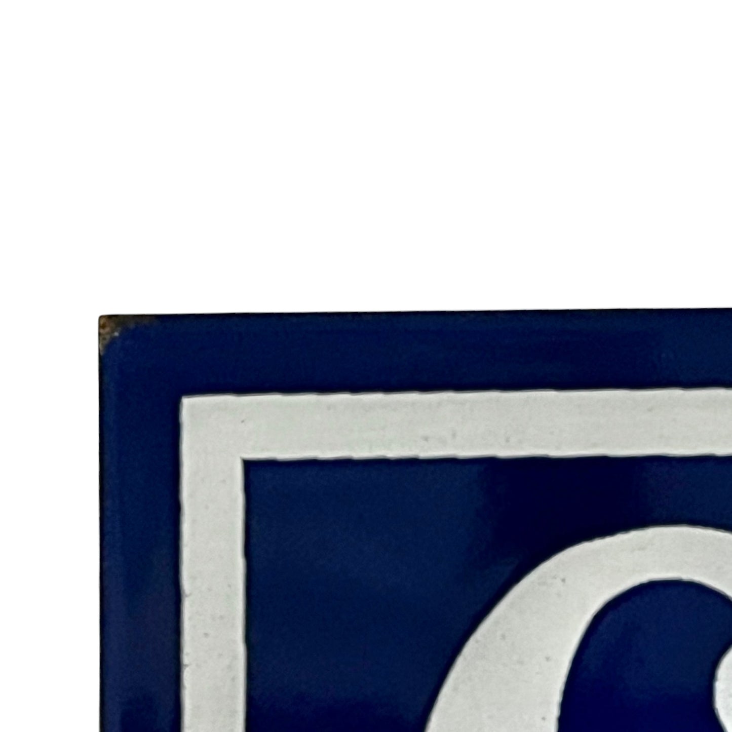 Close up of blue and white door number 65 on a white background 