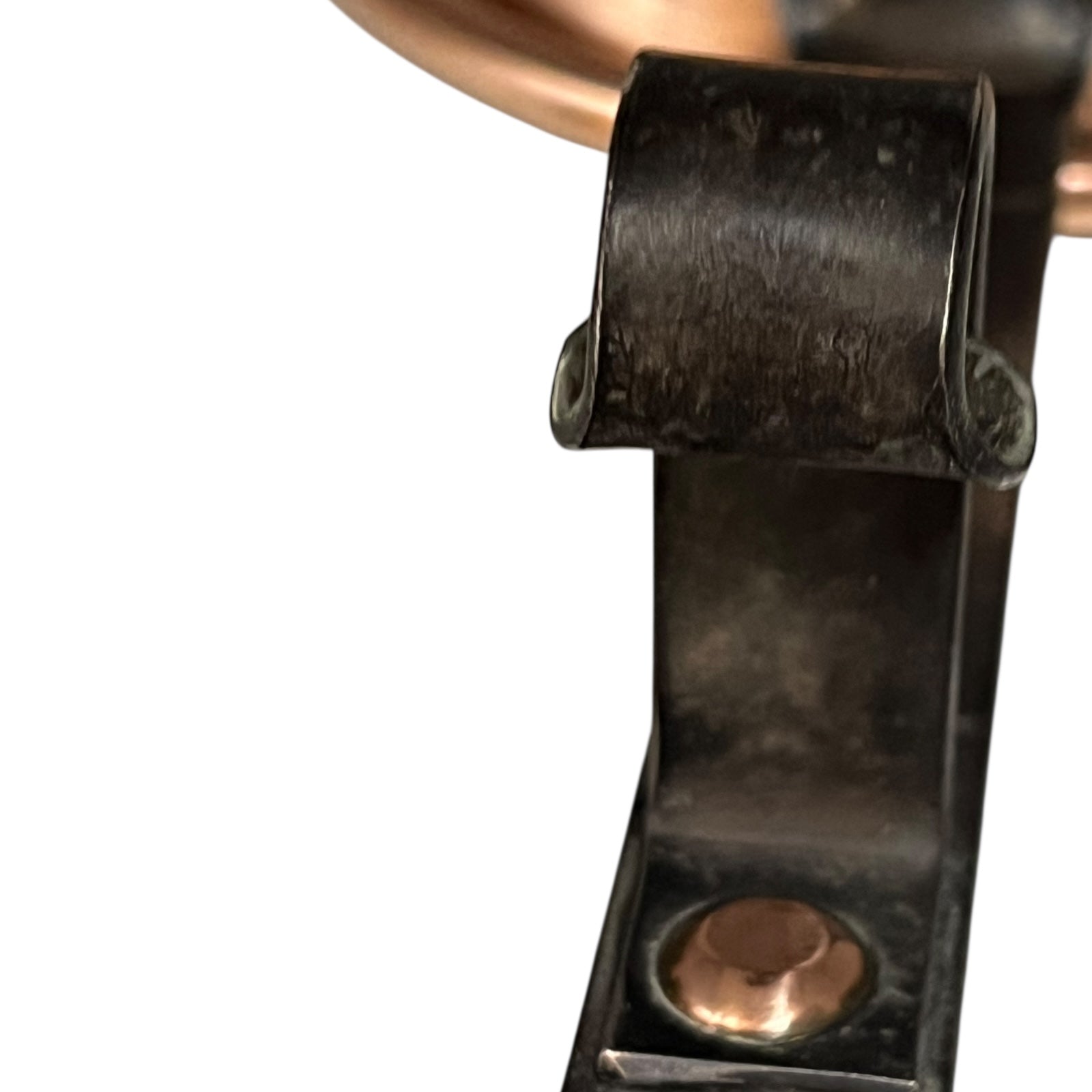 Close-up of a copper pan with a black handle on a white background 