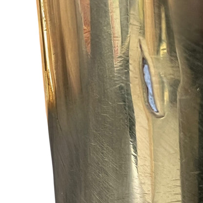 Close-up of a brass trench art shell case on a white background 