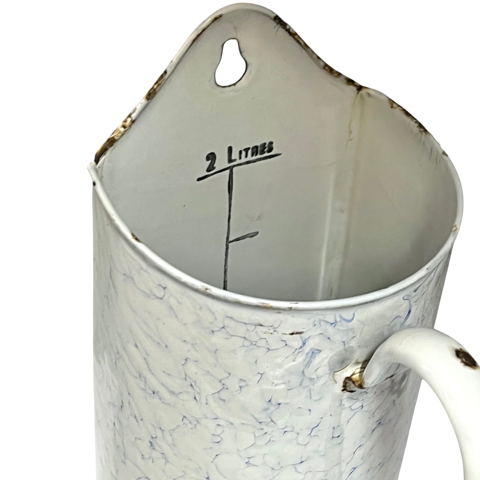 A vintage white enamel shower caddy with a marbled crackle pattern, featuring a hanging loop, a handle, and '2 Litres' printed inside.