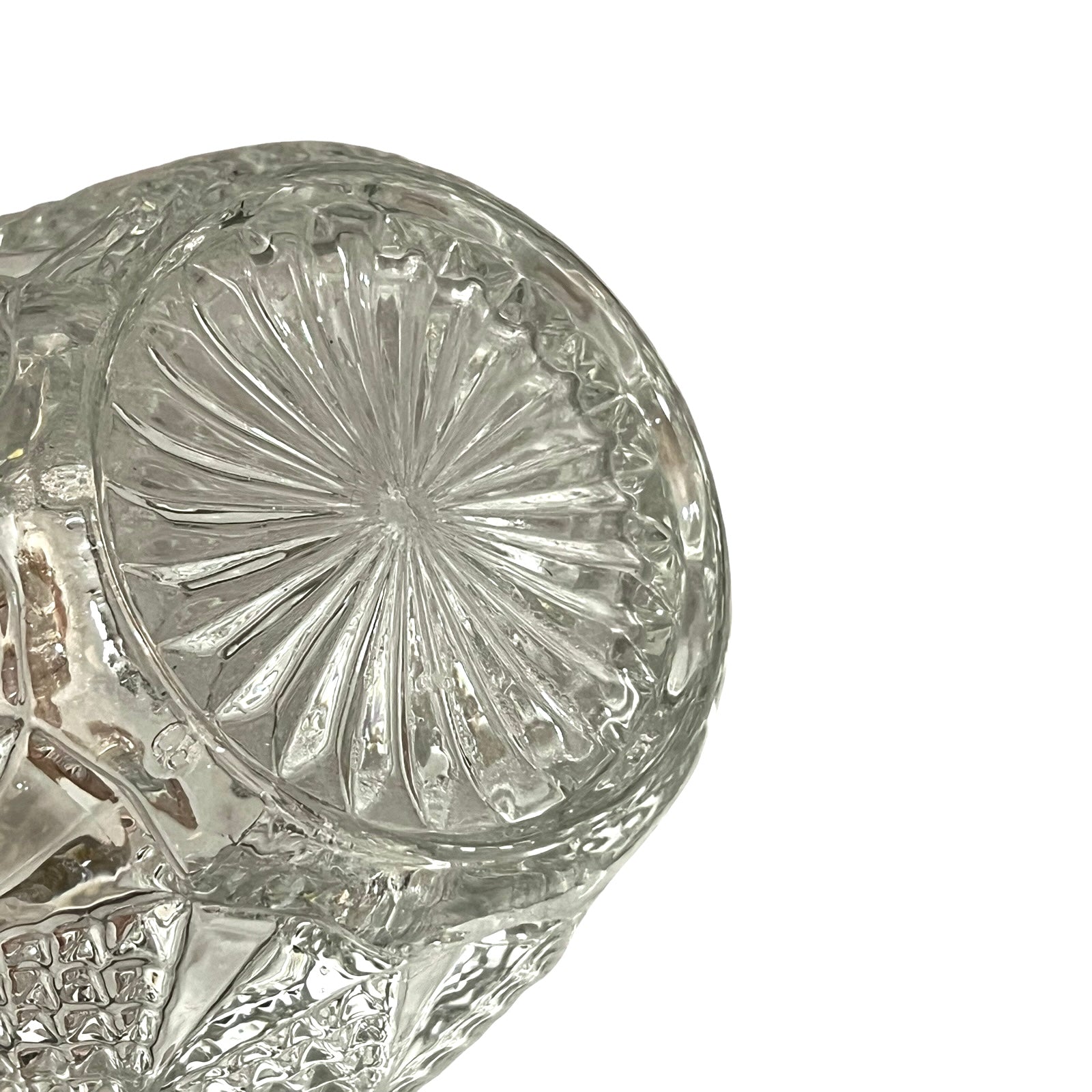 Close-up of a crystal ice bucket with silver lid and handle on a white background