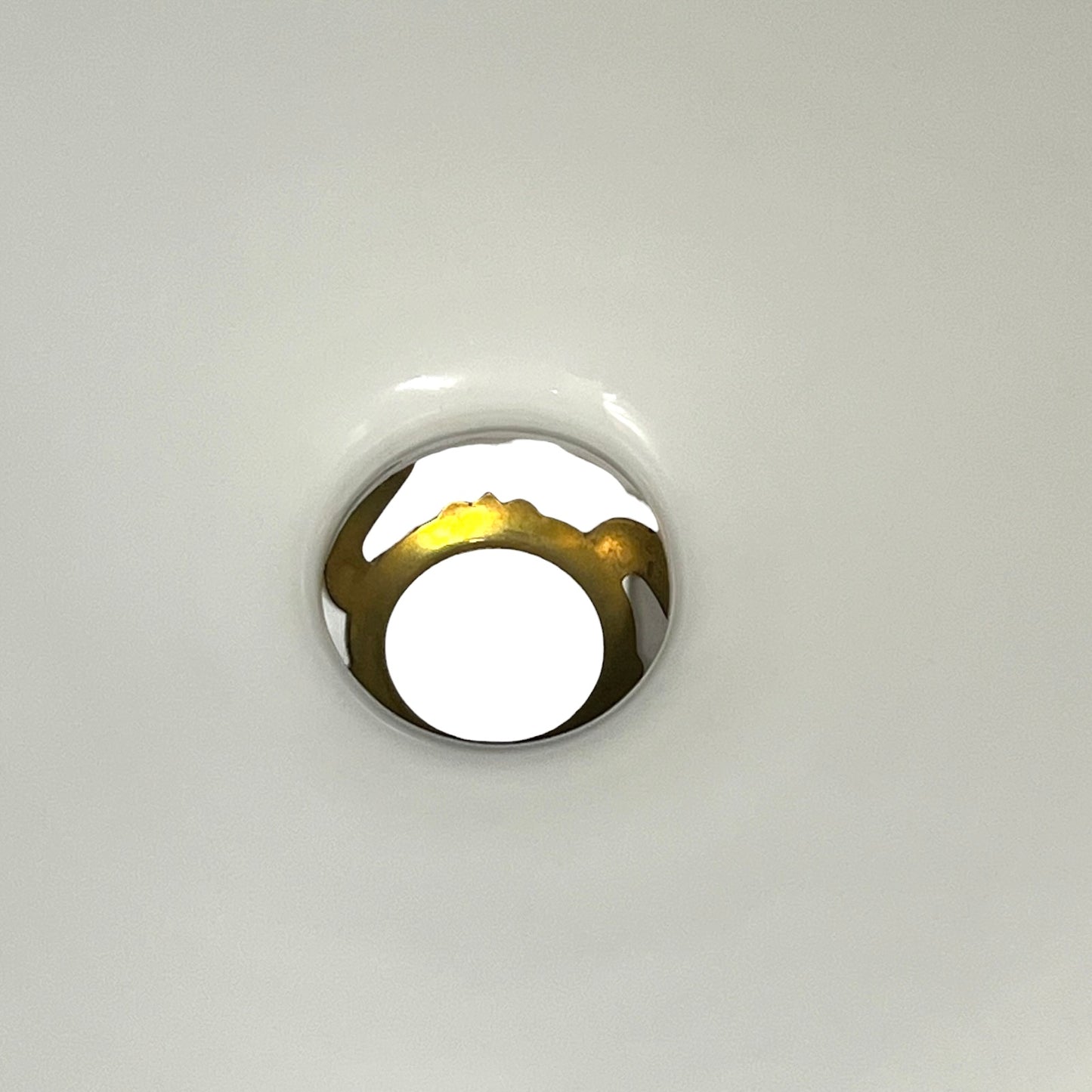 A close-up of a white glass shade and gallery