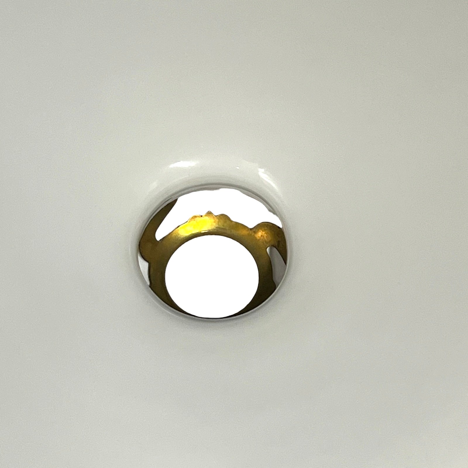 A close-up of a white glass shade and gallery