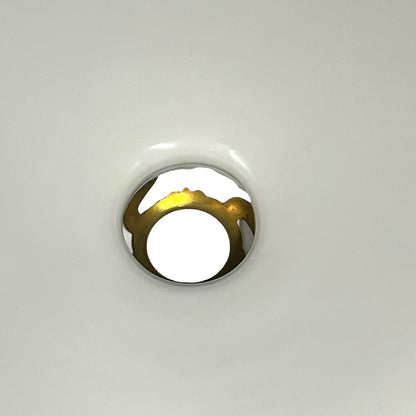 A close-up of a white glass shade and gallery