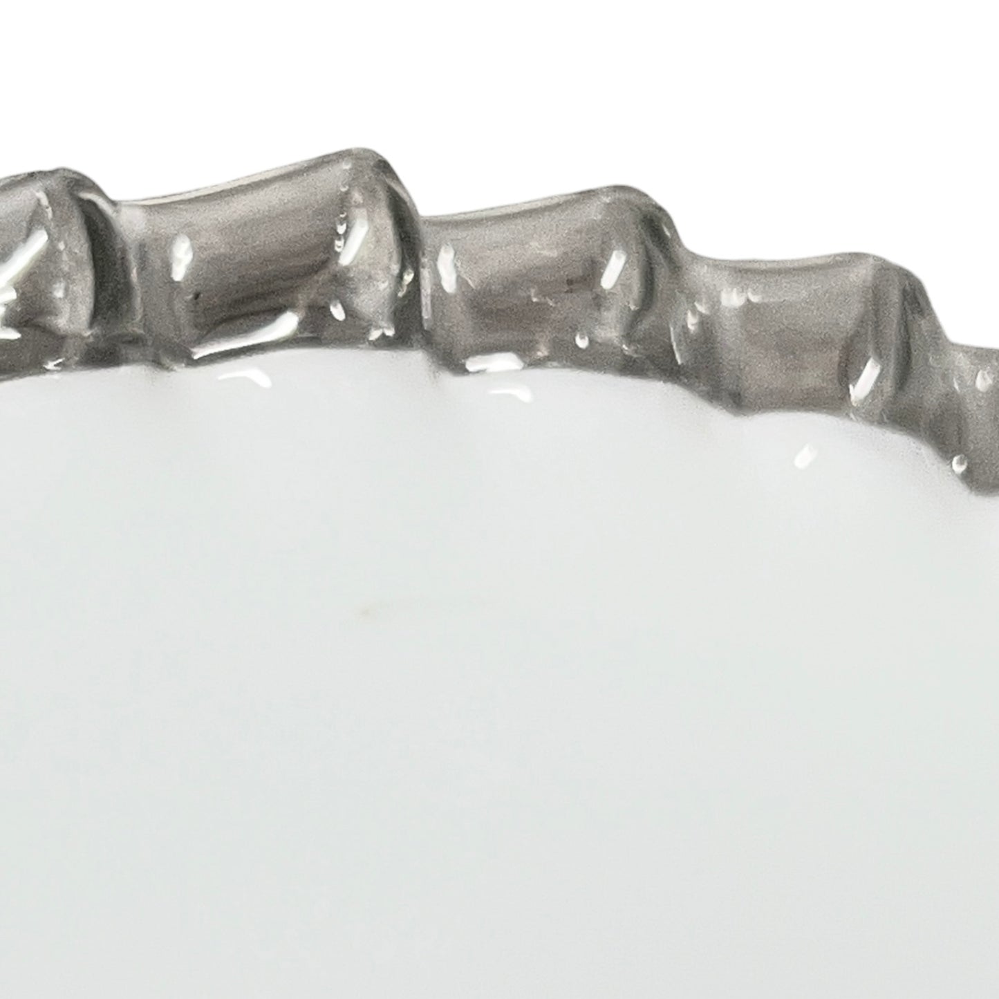 Close-up of a glass lampshade with a decorative edge on a white background