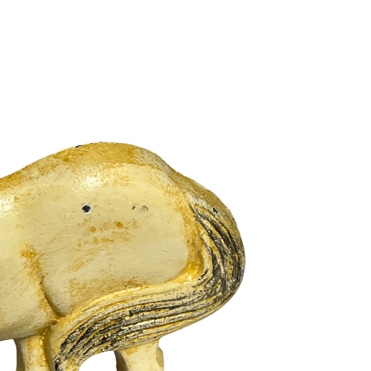 Close-up of the rear and side of a small horse figurine or sculpture, shown against a plain white background. The body is cream-colored with a warm yellow-gold patina and dark brown to black painted stripes along the mane.