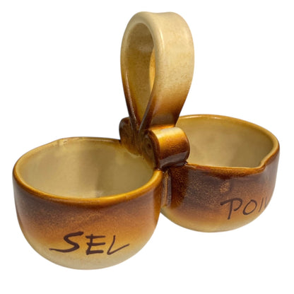 Ceramic salt and pepper shaker set with 'SEL' and 'POIVRE' writing on a white background