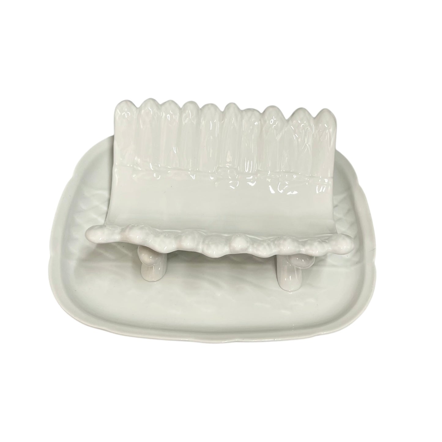 white ceramic asparagus serving dish displayed on a tray on a white background 