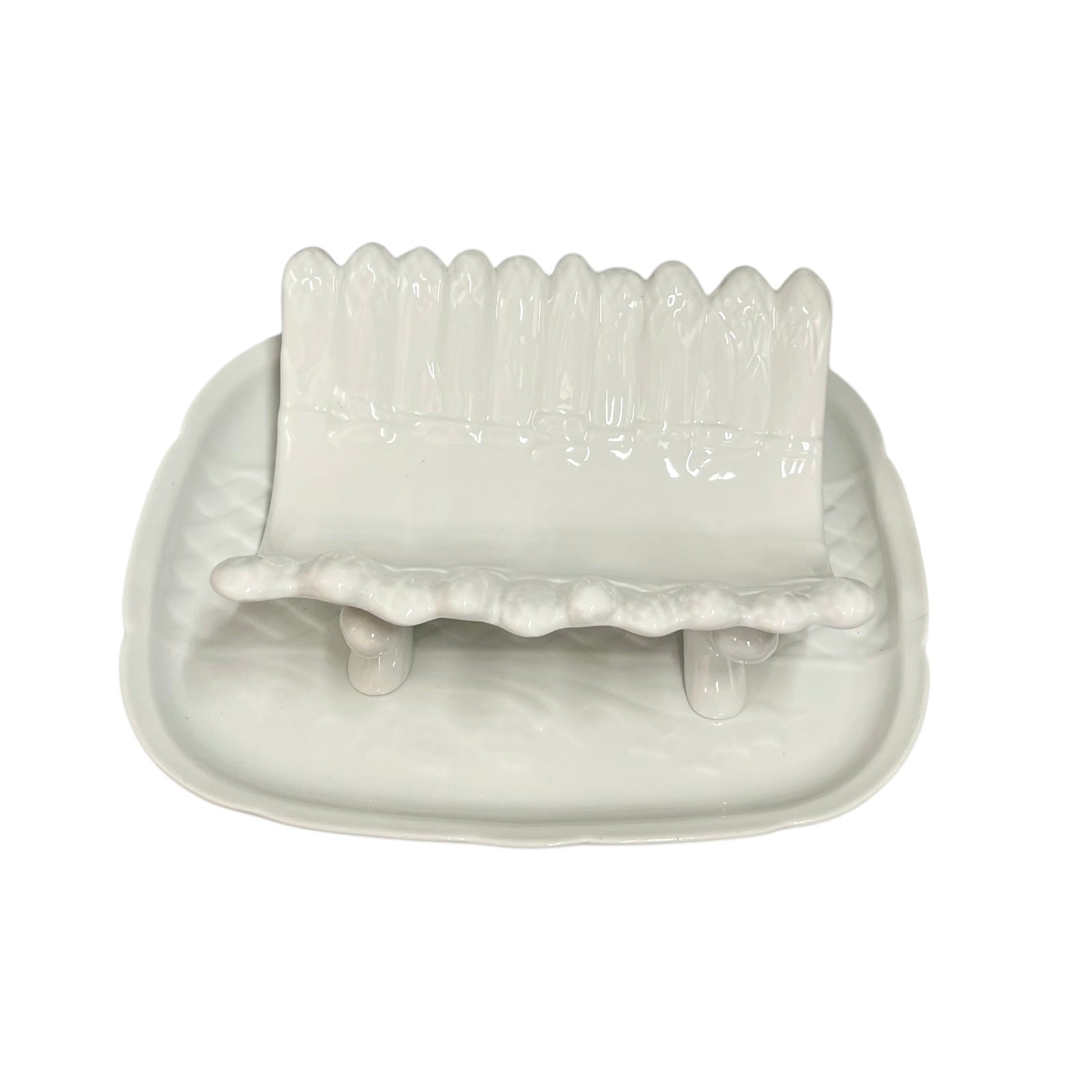 white ceramic asparagus serving dish displayed on a tray on a white background 