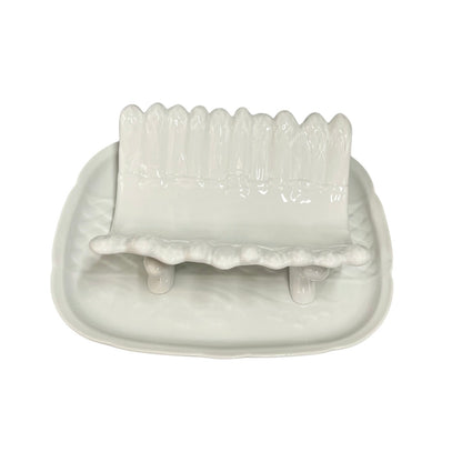 white ceramic asparagus serving dish displayed on a tray on a white background 