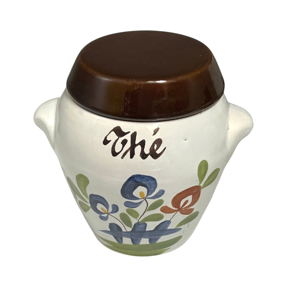 A small white ceramic canister with a dark brown lid, decorated with blue and orange flowers, green leaves, and the word 'Thé' in black script.