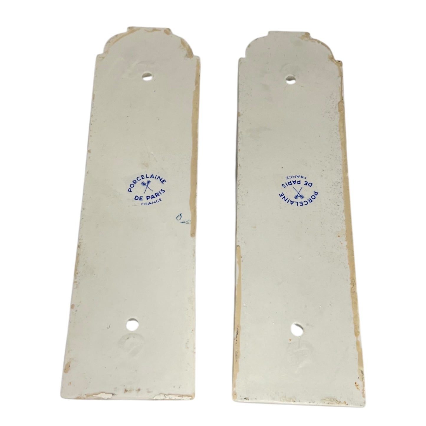 close up of door push plate with a Paris makers stamp on a white 