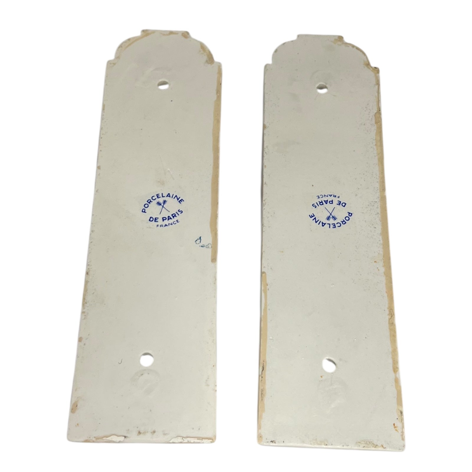close up of door push plate with a Paris makers stamp on a white 