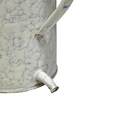 Close-up of a vintage white enamel watering can with a blue crackle glaze pattern and a metal spout, set against a plain white background.