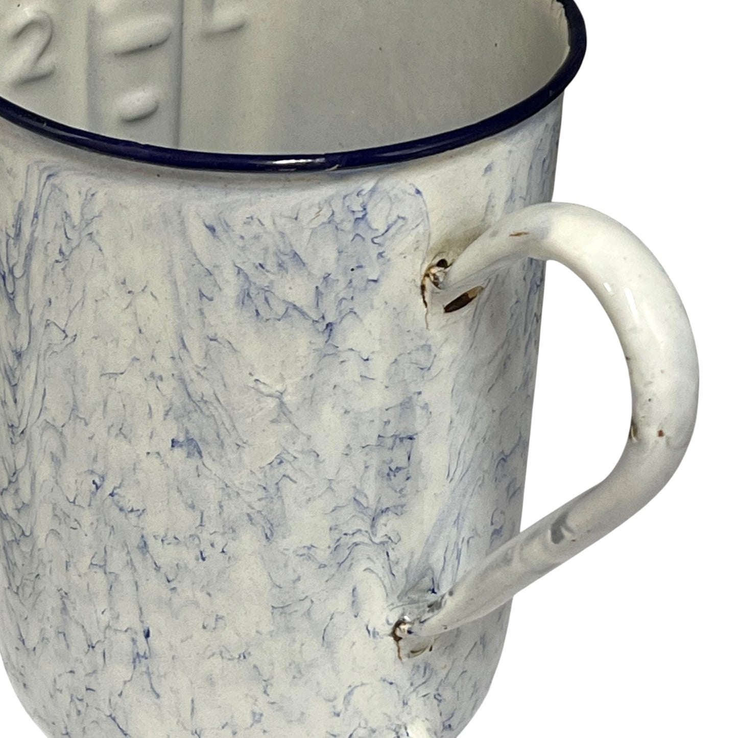 A close-up of a vintage enamel storage pot with a white marbled blue pattern, a dark blue rim, and a white handle.