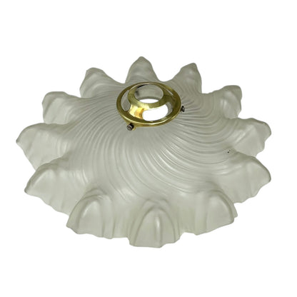 Decorative glass light fixture with a brass center on a white background