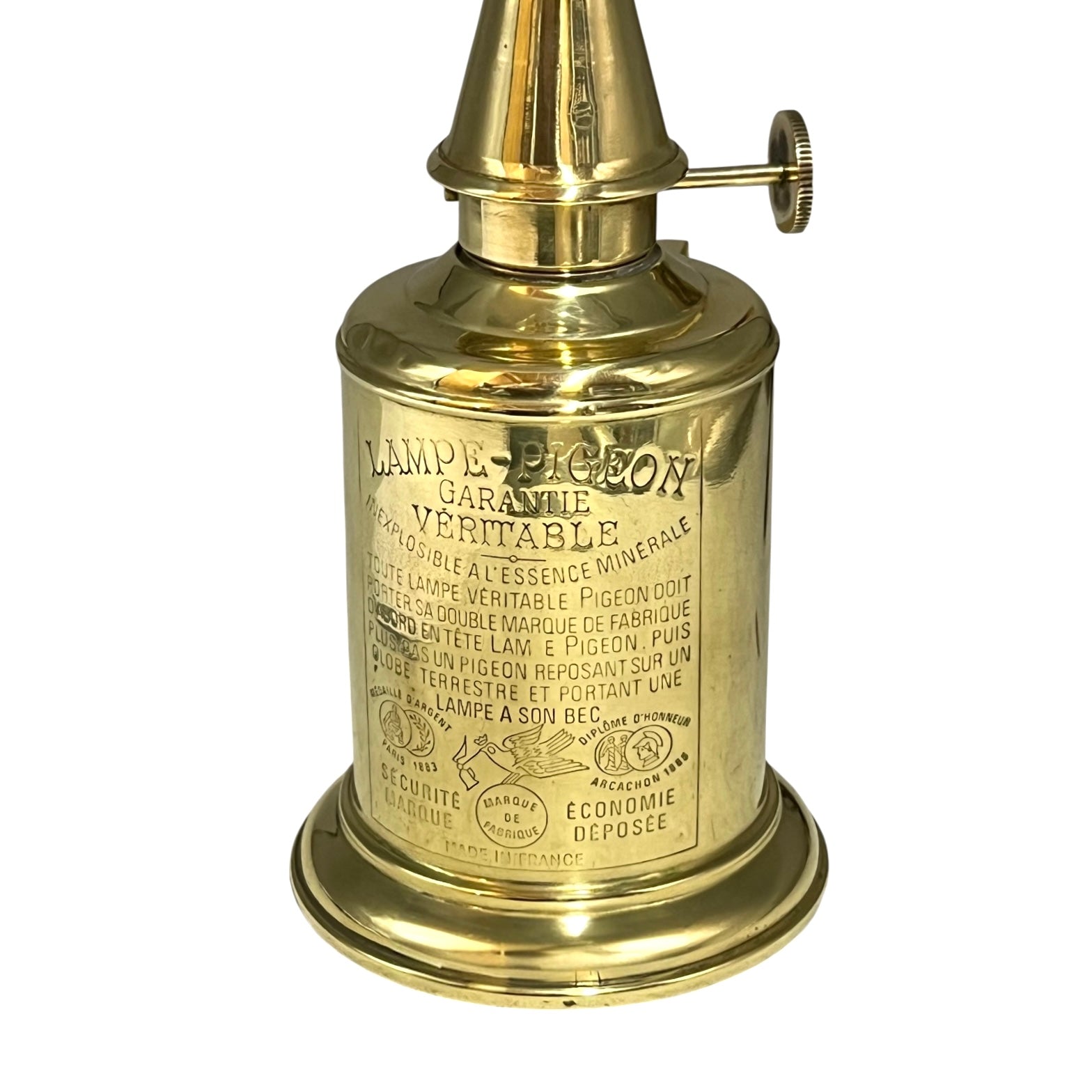 Brass lamp with intricate design and text on a white background