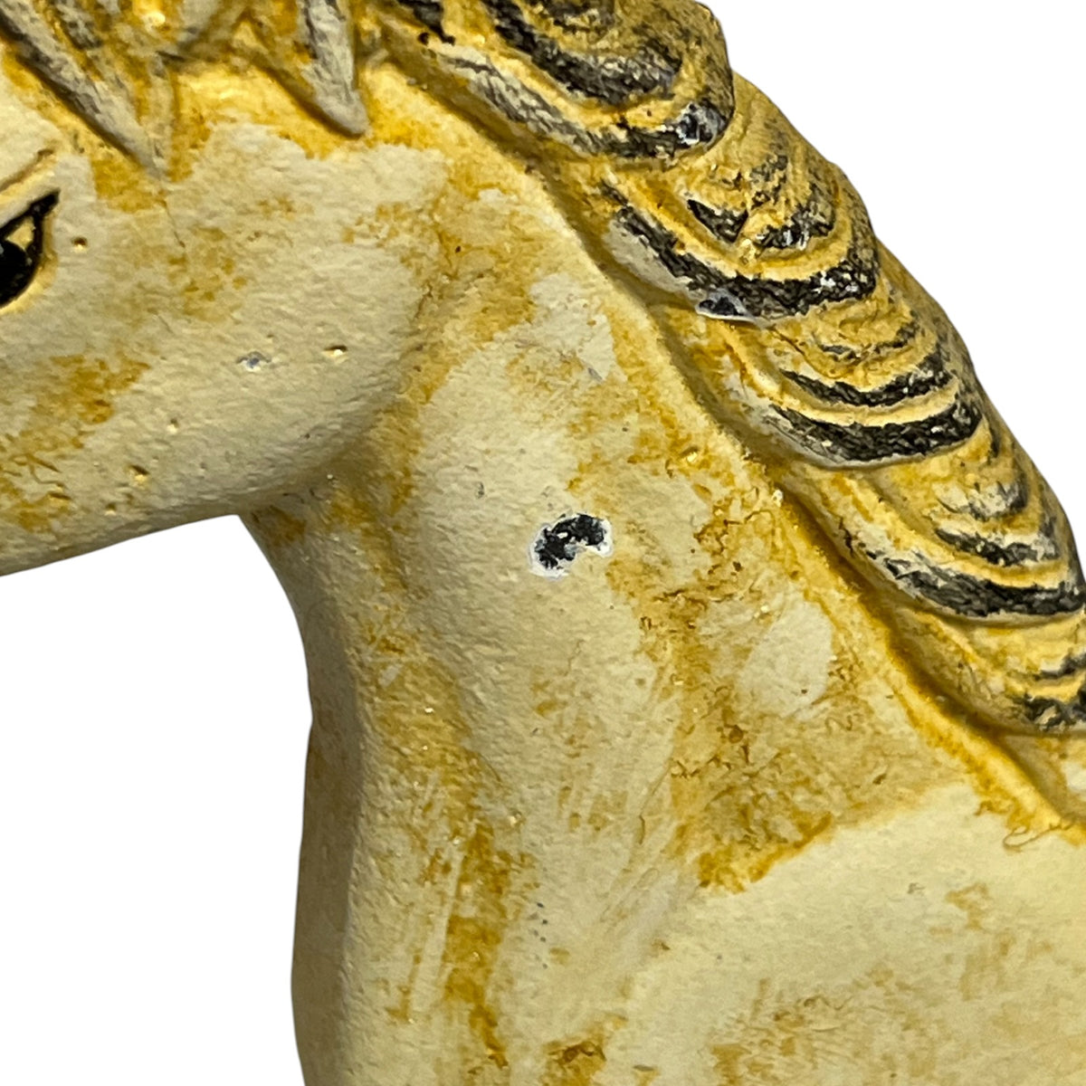 Close-up of a textured horse door stop  with a distressed yellow and beige finish, showing part of the neck, mane, and eye on a plain white background.