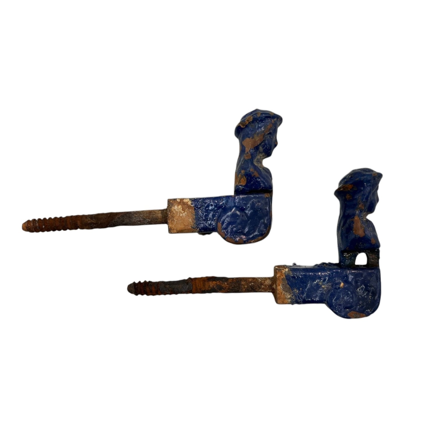 Pair of French cast iron shutter dogs painted blue with signs and age and wear on a white background