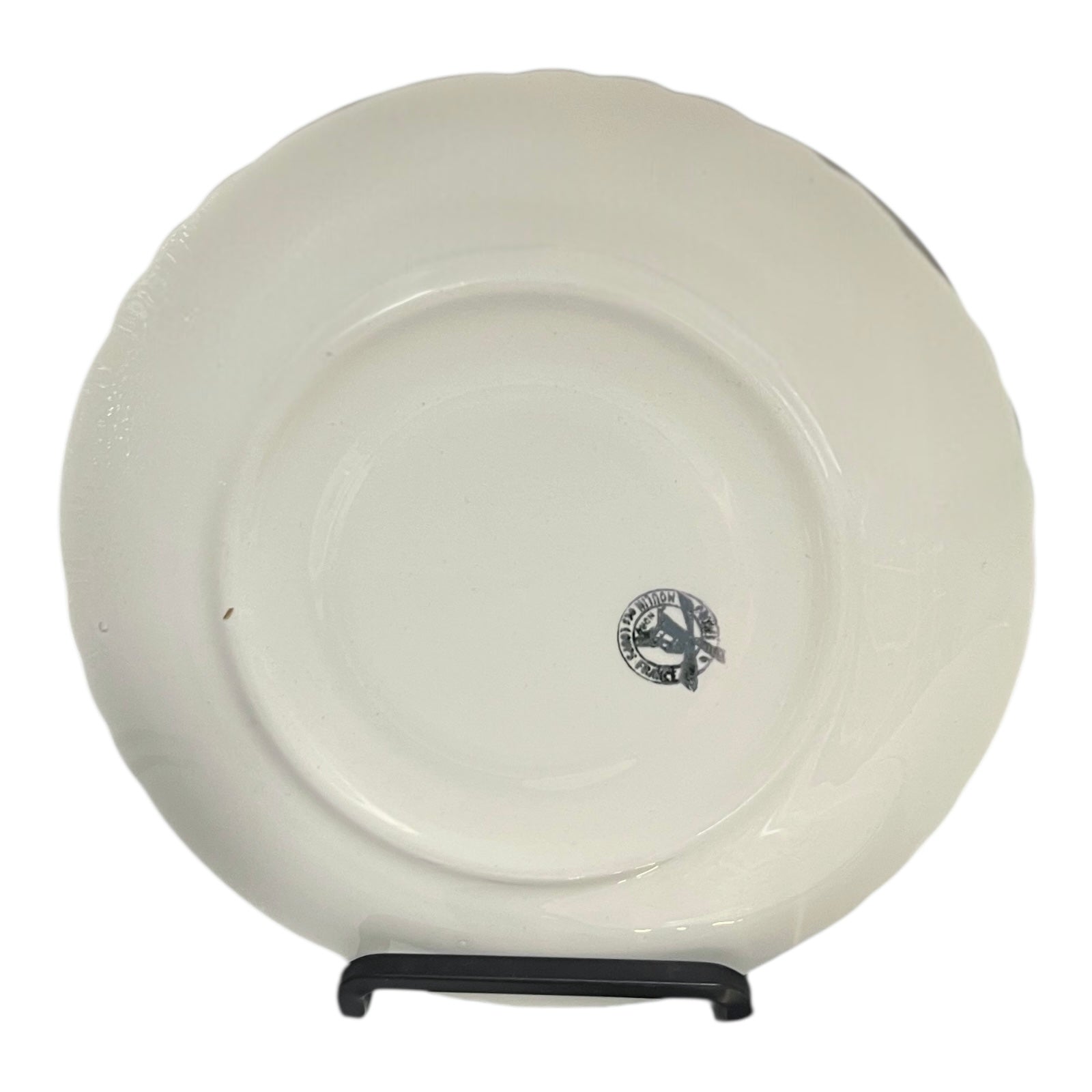 White ceramic plate with a logo on a stand against a white background