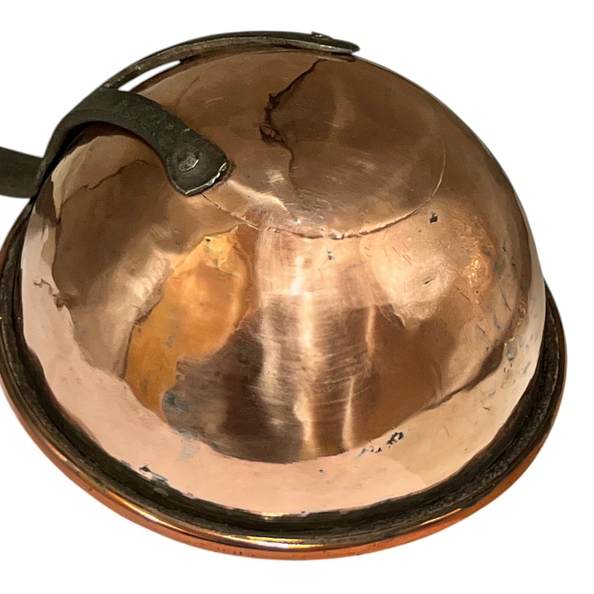 A vintage copper dome-shaped pot lid or cover with a dark metal handle, shown on a plain white background.